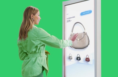 Woman using unattended payment solution with touch screen