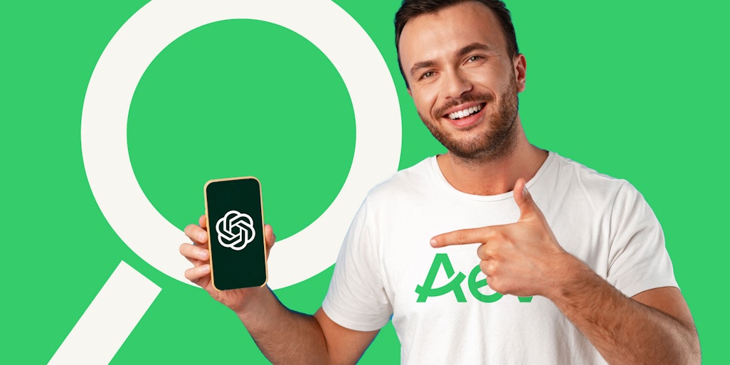 Man with phone showing Chat-GPT logo