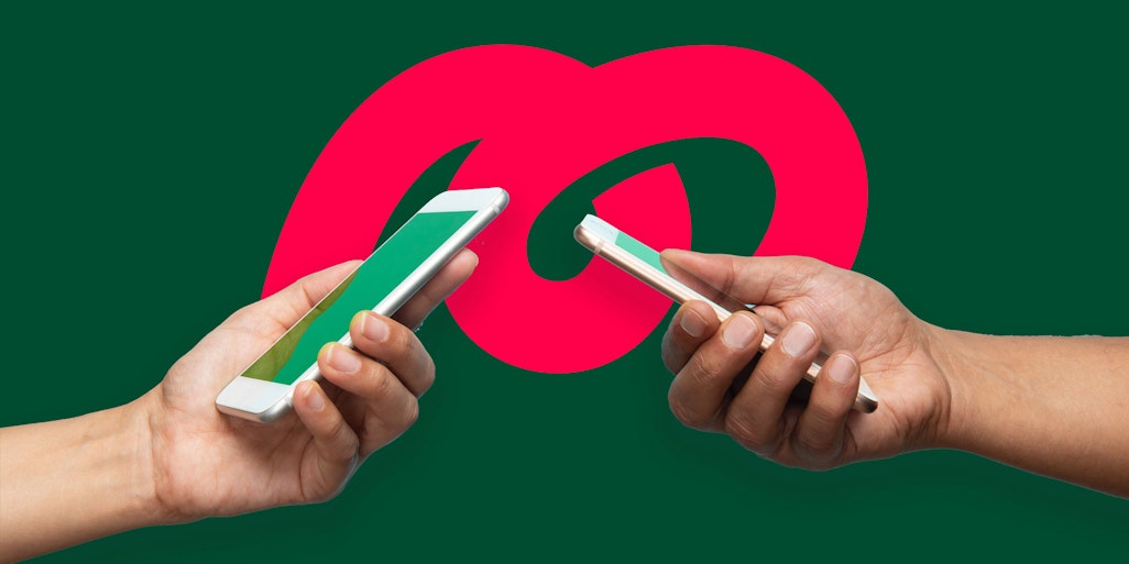 two hands holding iphones