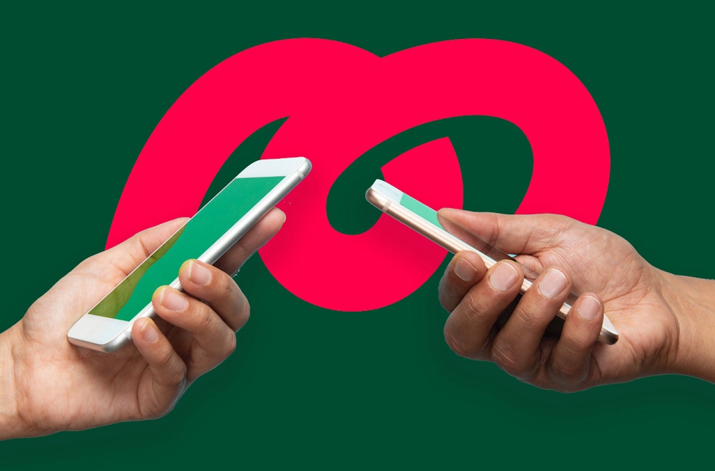 two hands holding iphones