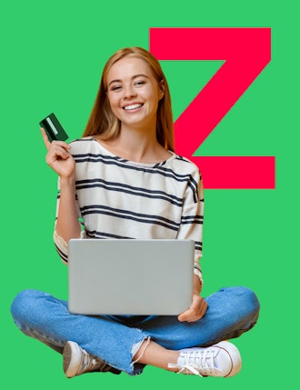 Woman holding card and laptop