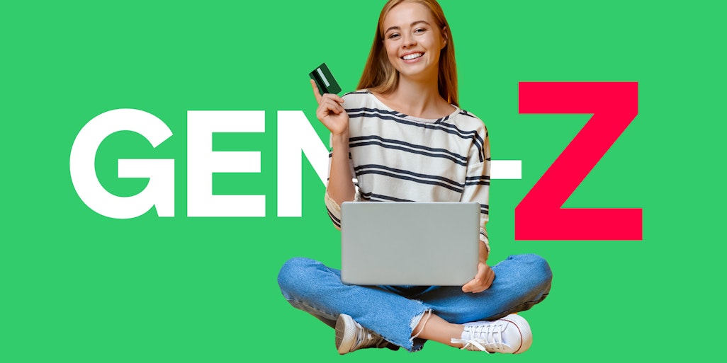 Woman holding card and laptop