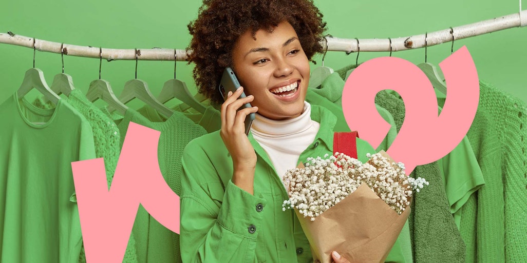Woman holding phone and flowers