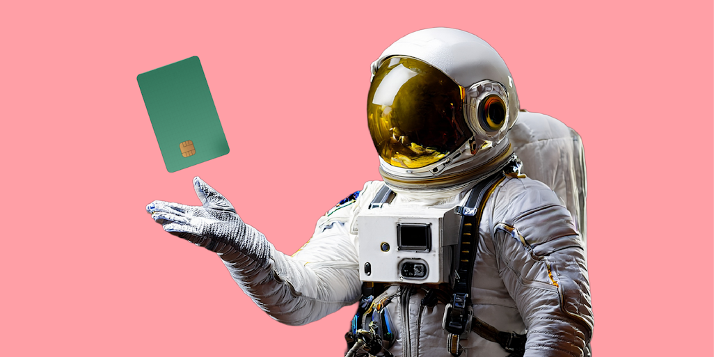 an astronaut holding a payment card
