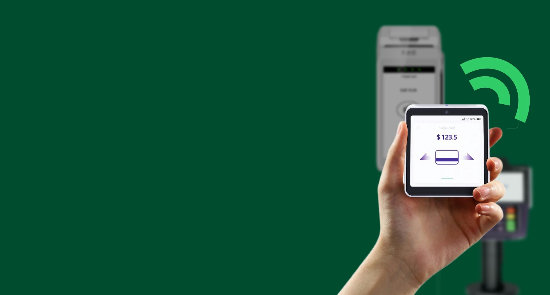 Hand holding card machine, with other payment terminals in the background, showing Aevi's vendor agnostic aproach