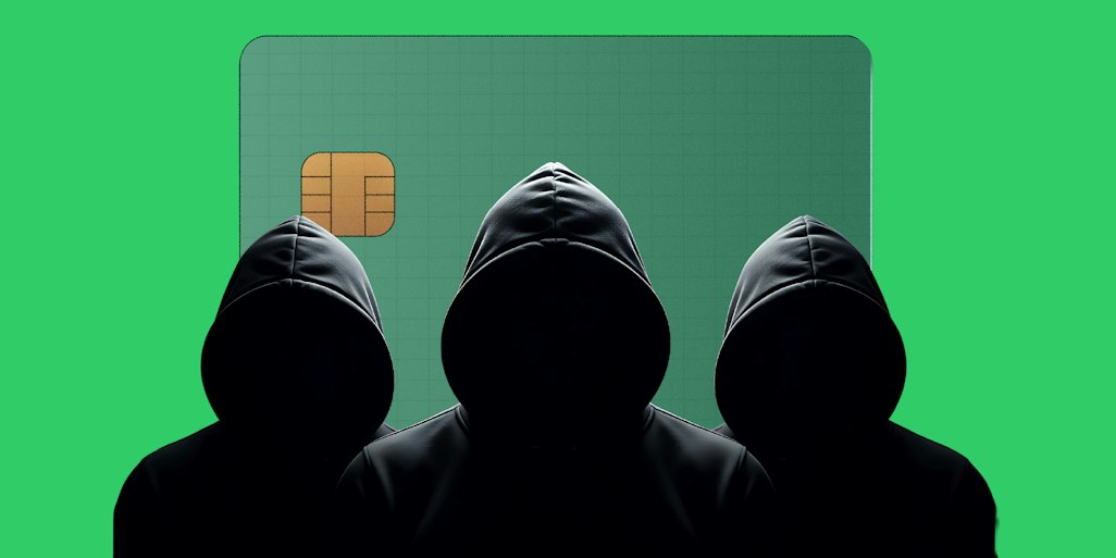 hooded figures in front of payment card