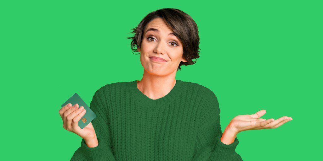woman shrugging holding payment card