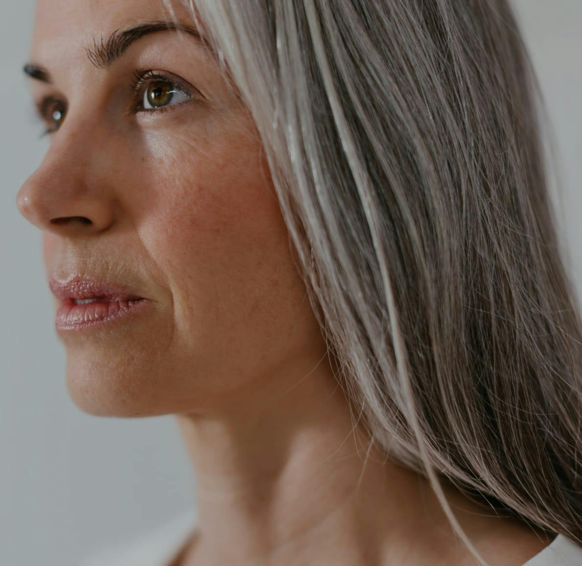 Woman with grey hair looking away