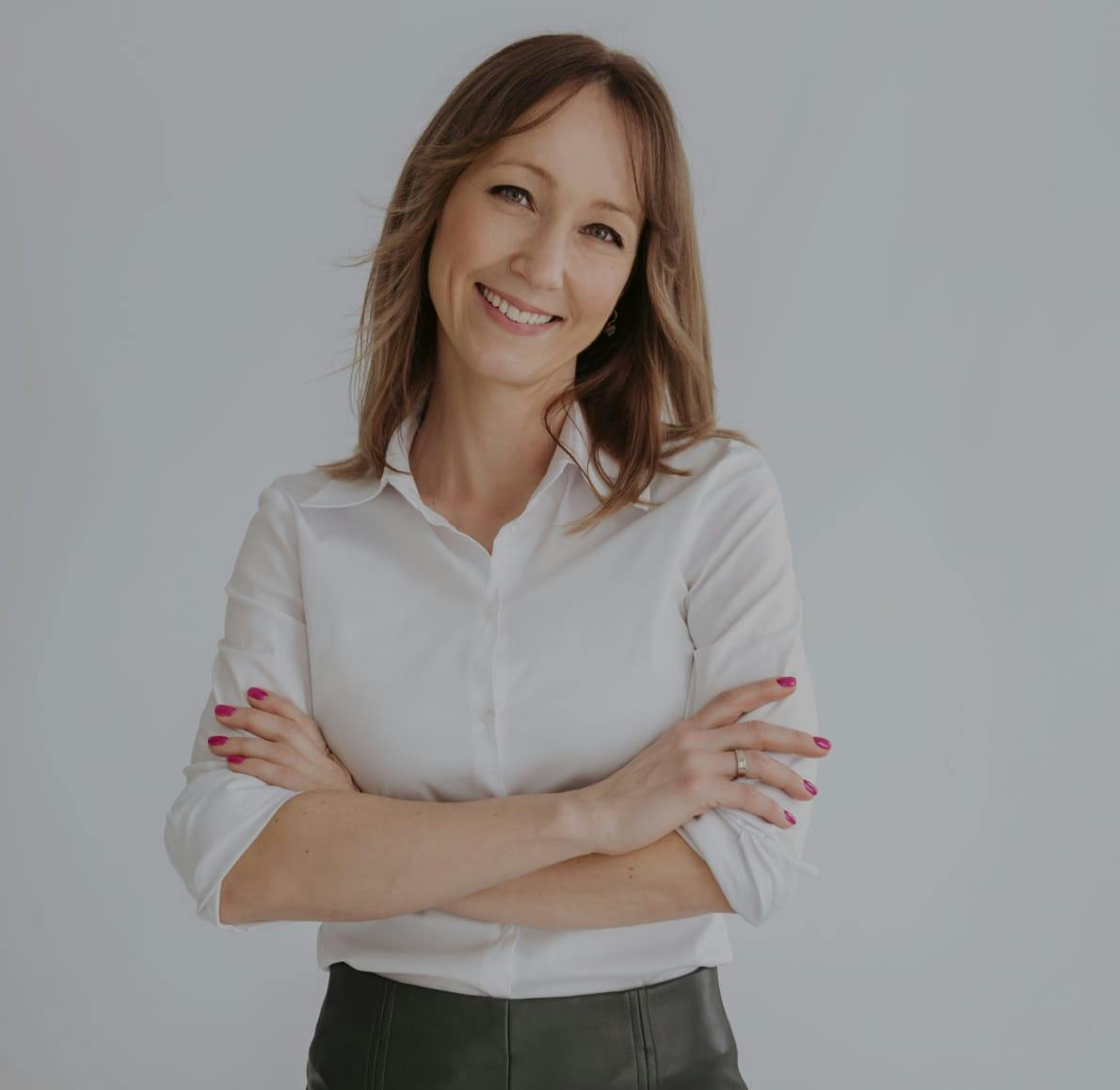 Woman smiling with arms crossed