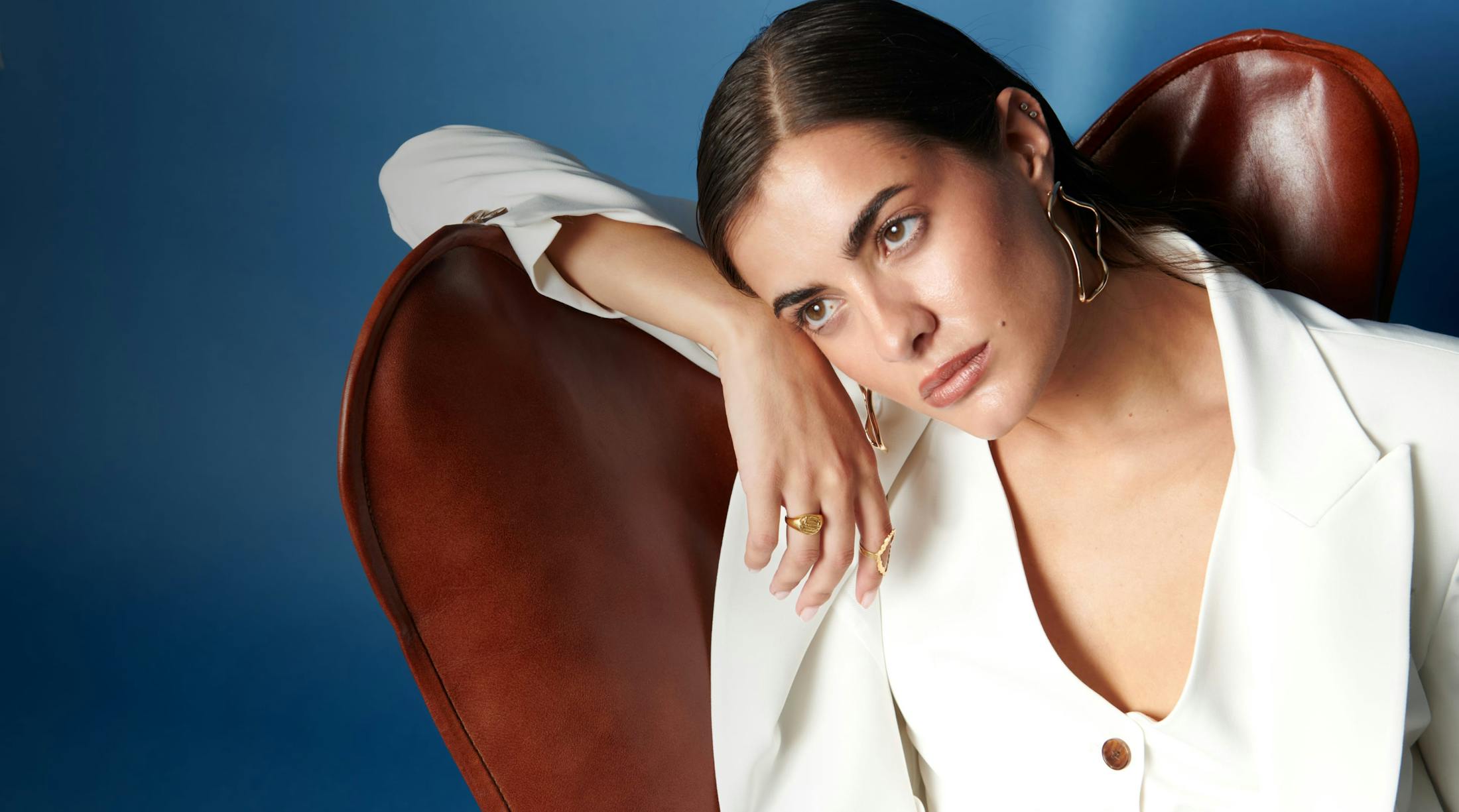 Woman sitting in chair resting head