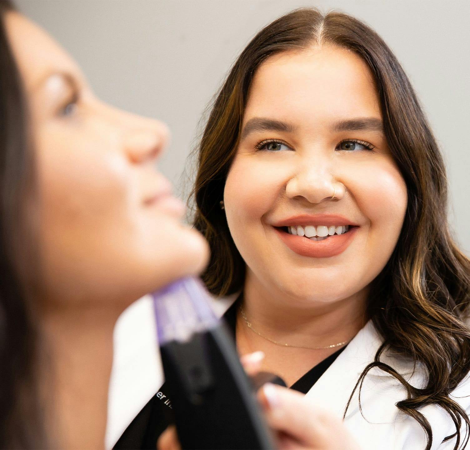 Patient receiving microneedling treatment under the chin