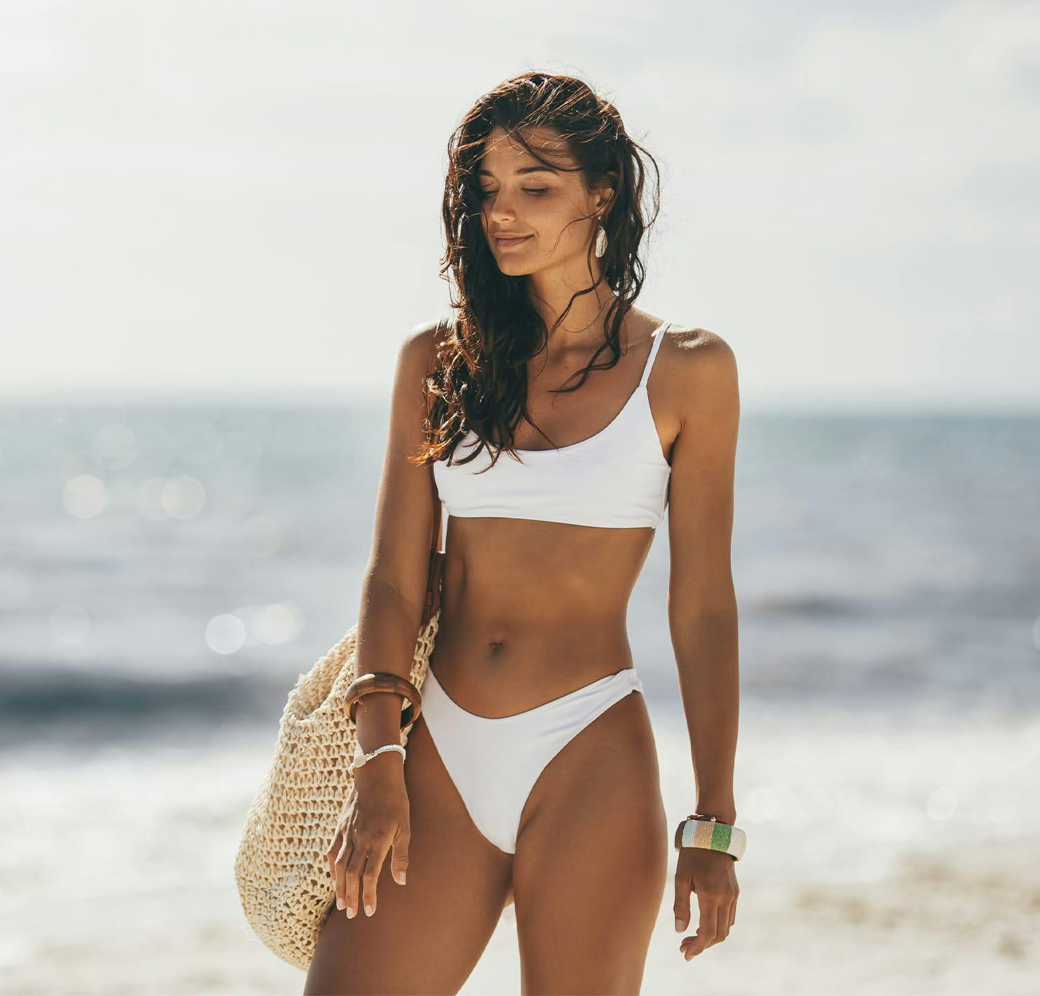 Woman in white bikini at the beach