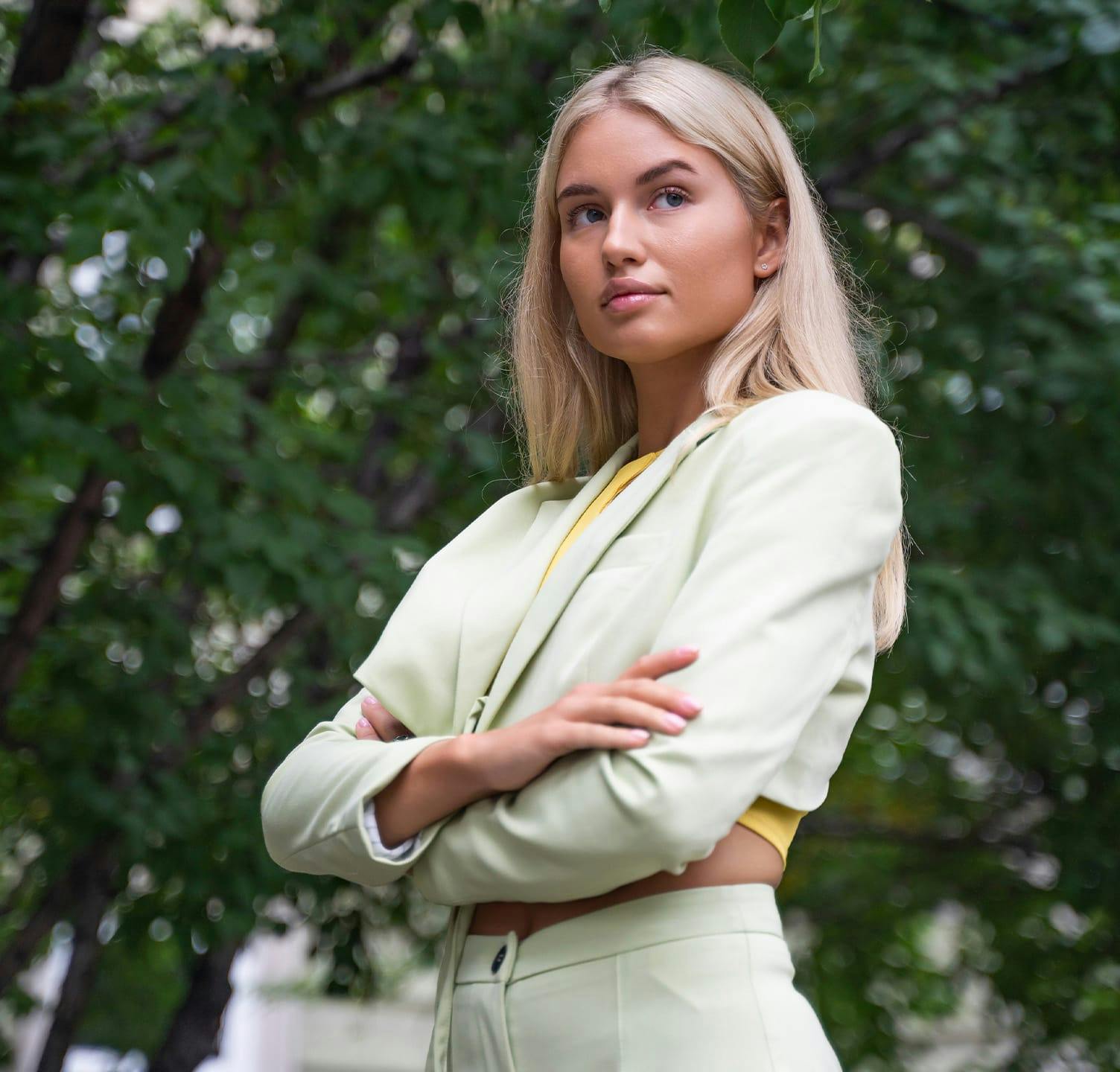 woman with arms crossed looking off into the distance