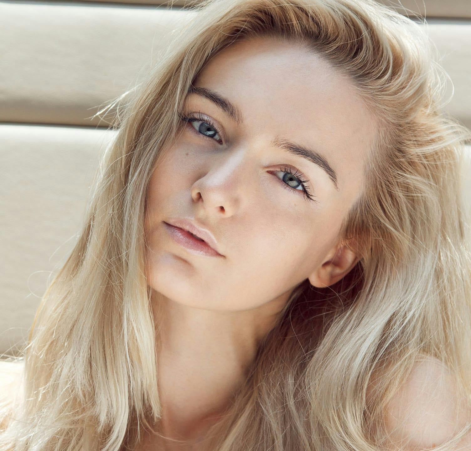 woman looking into camera tilting her head