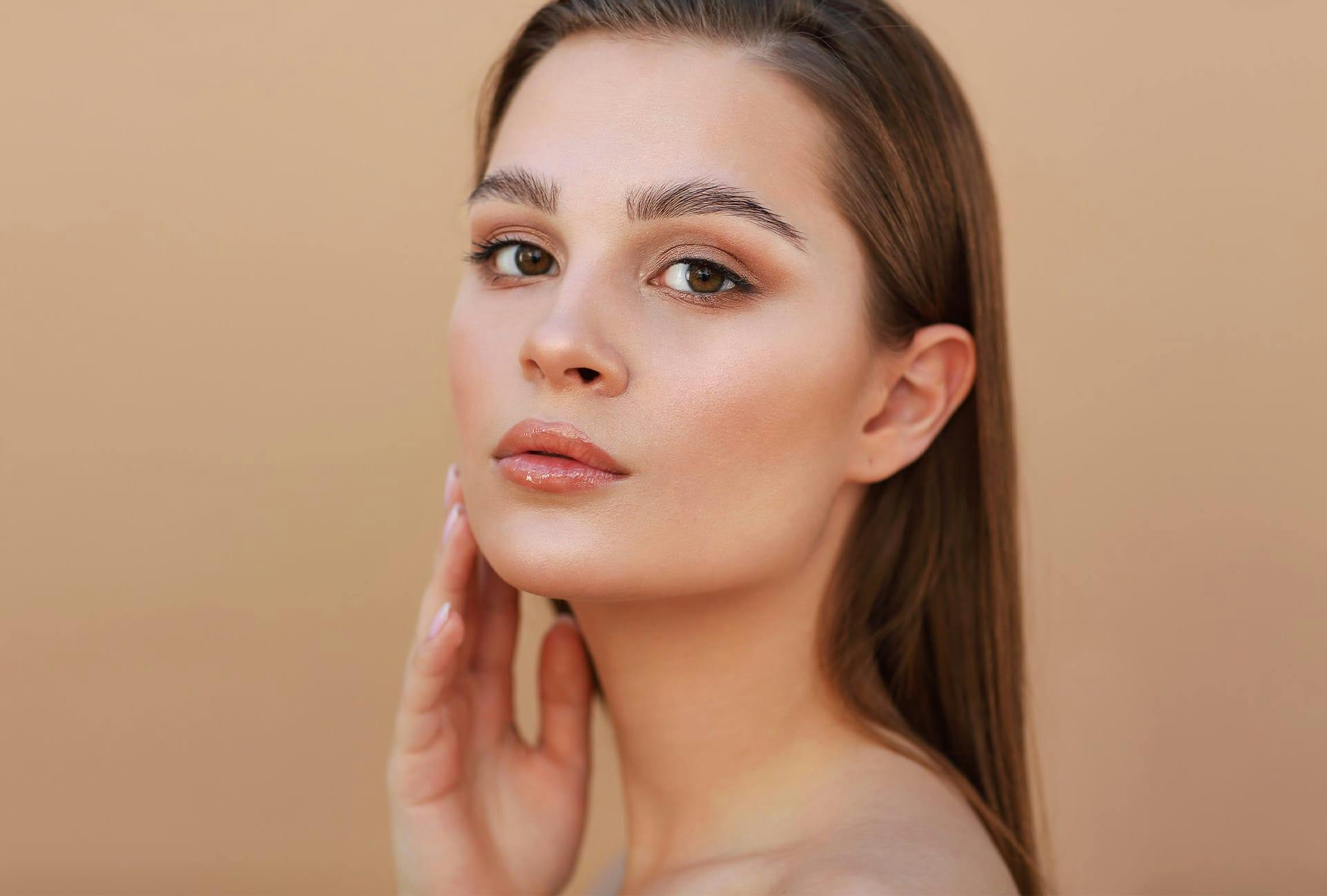 Woman feeling her chin and cheek