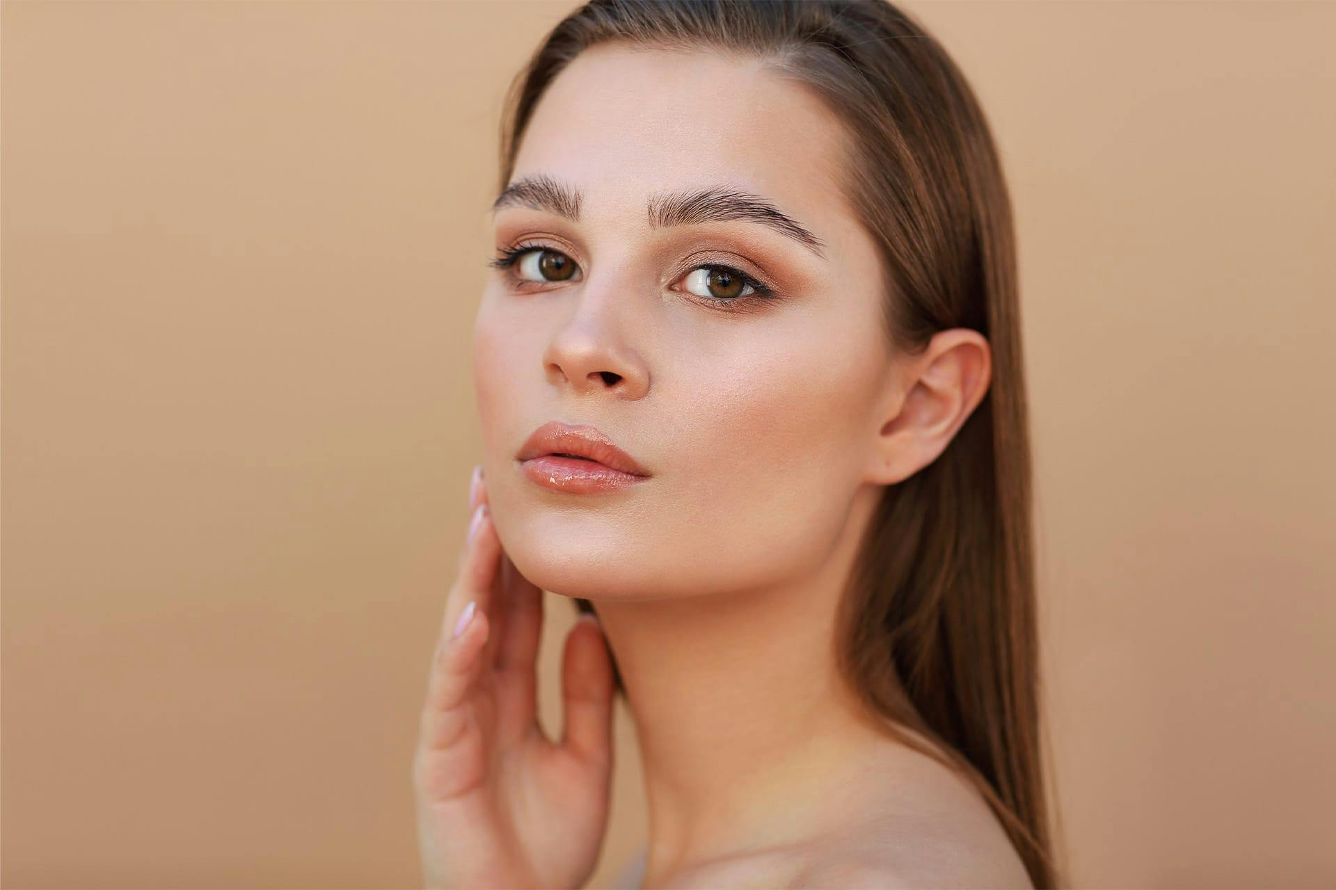 Young woman touching face and posing