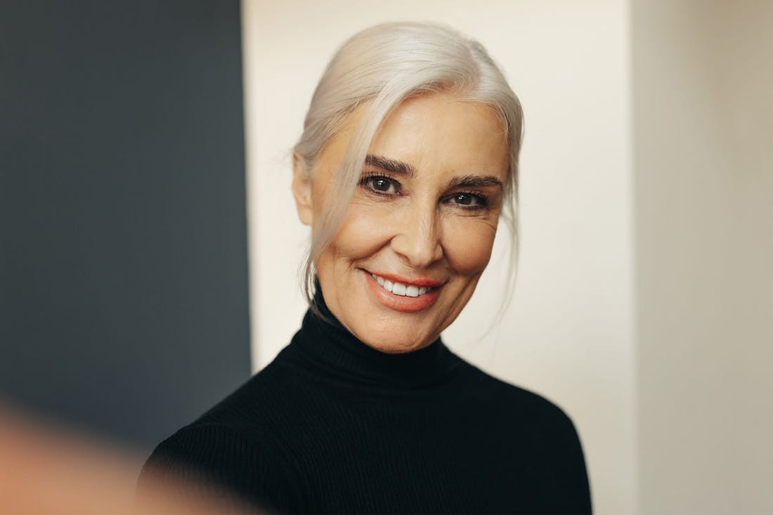 Smiling older woman in black turtleneck