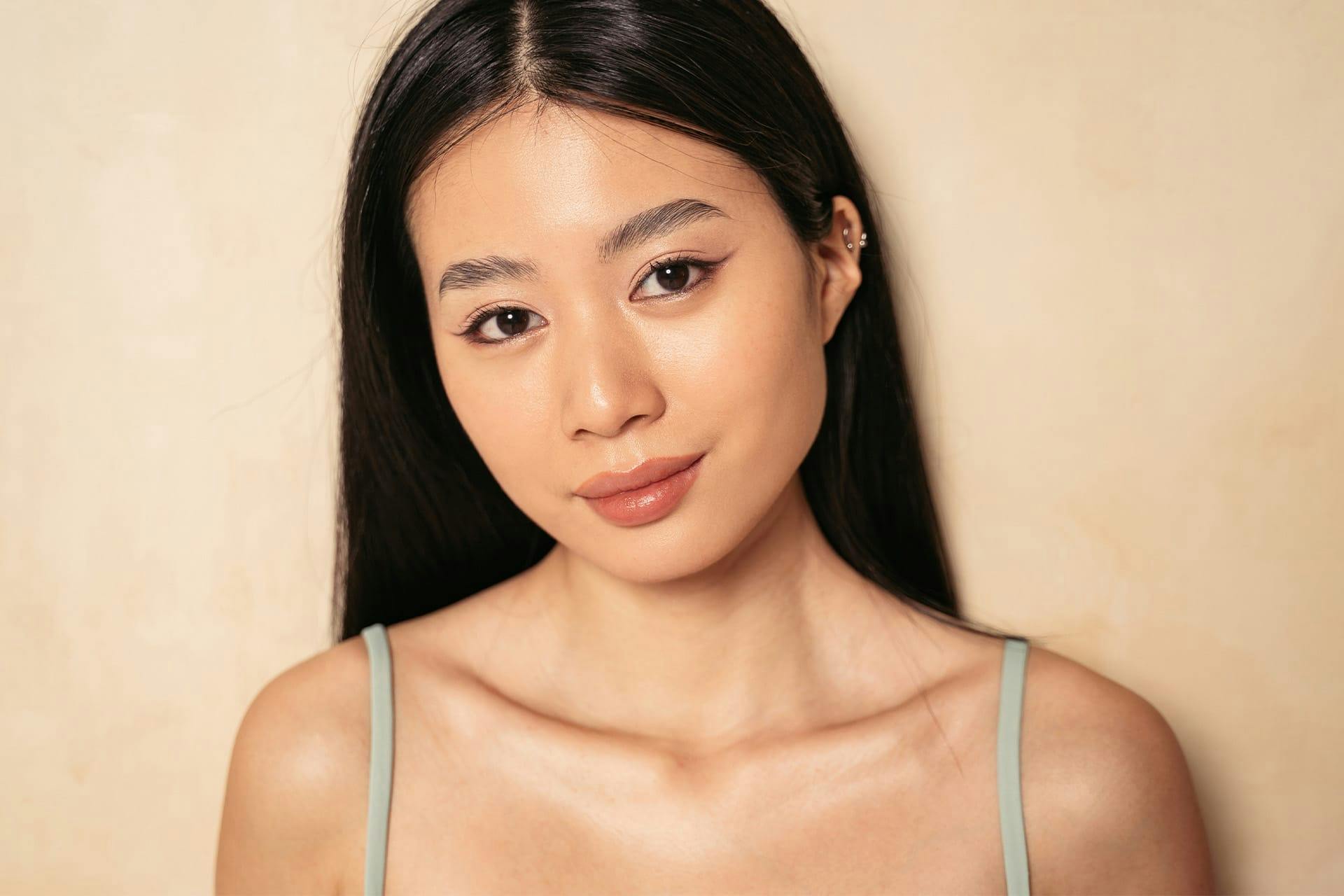 Young woman with green dress and ear piercings