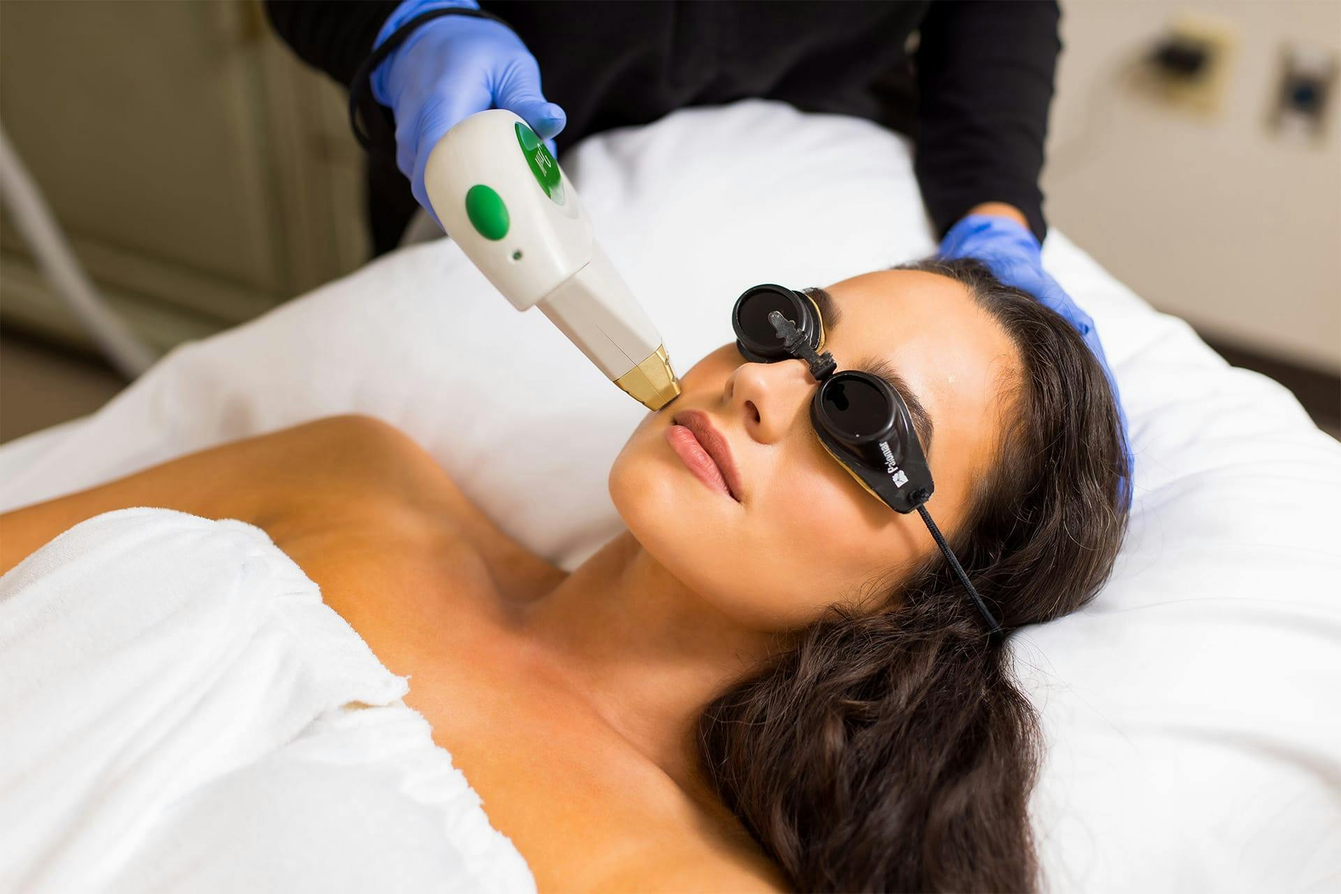 Woman receiving laser skin procedure