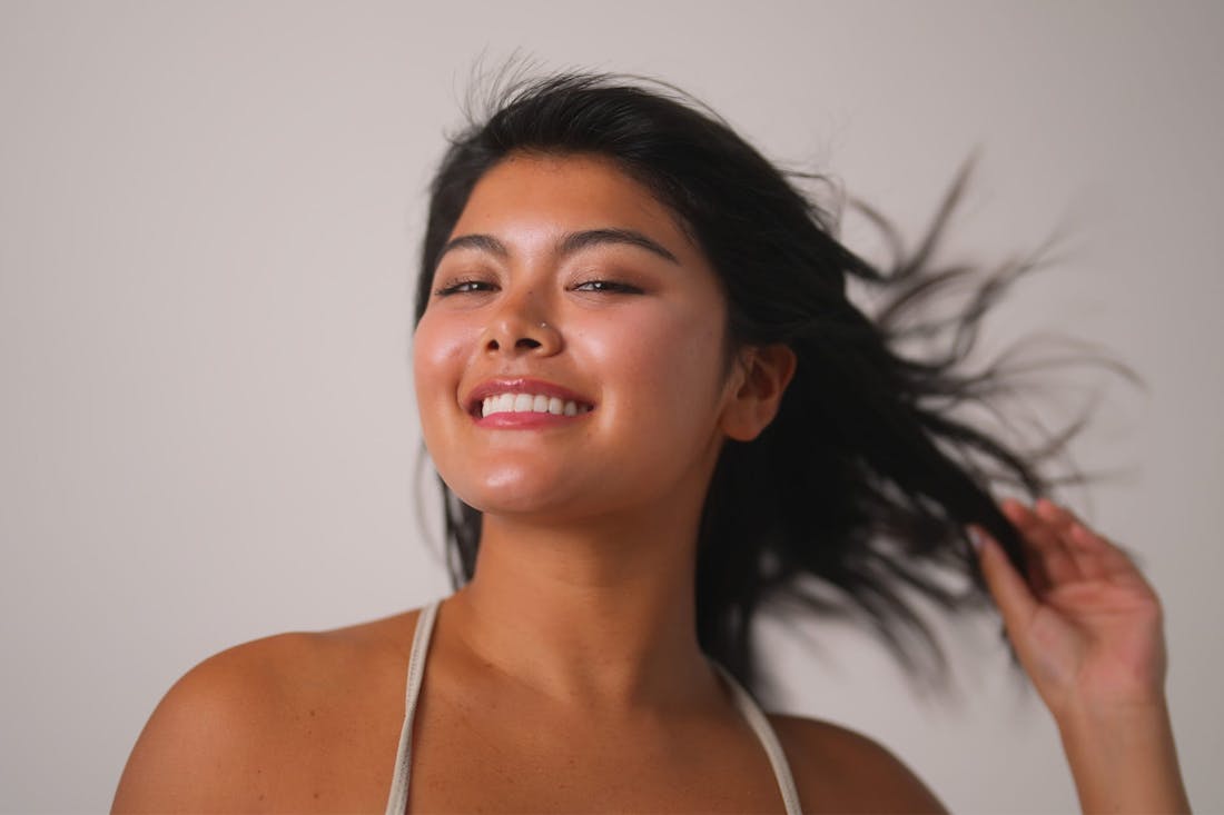 Smiling woman with hair blown