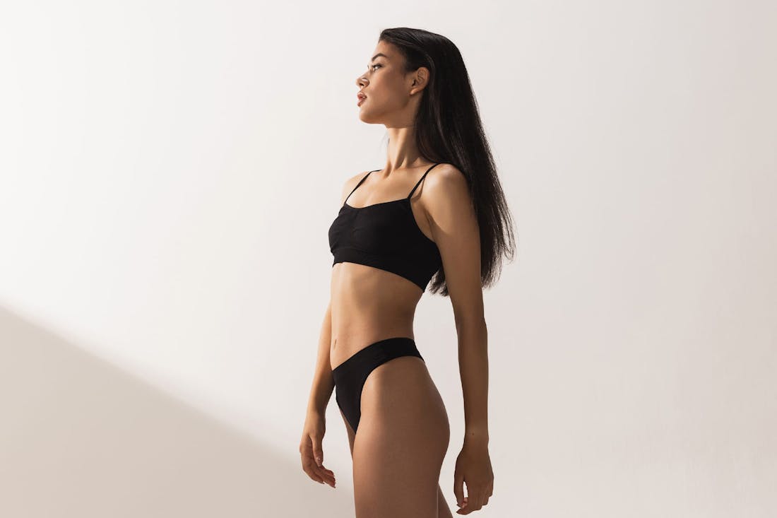 Woman in black bra and underwear posing