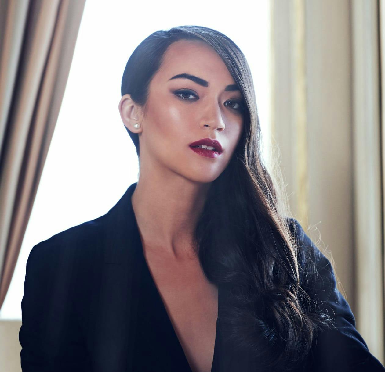 A model with dark hair posing