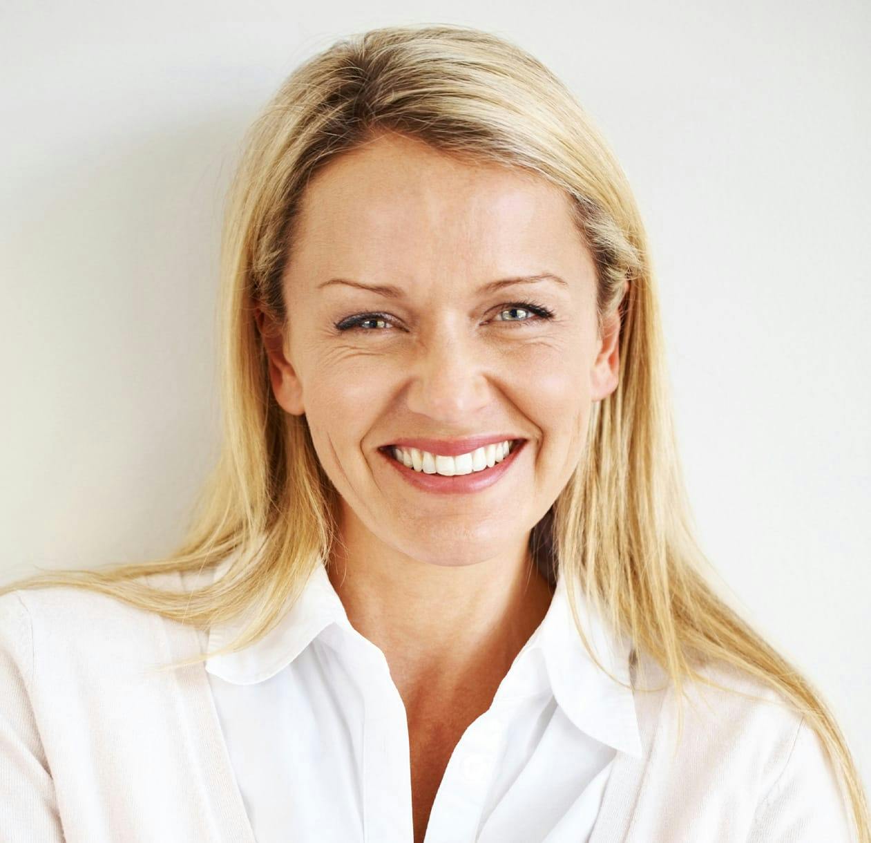 A blonde woman smiling