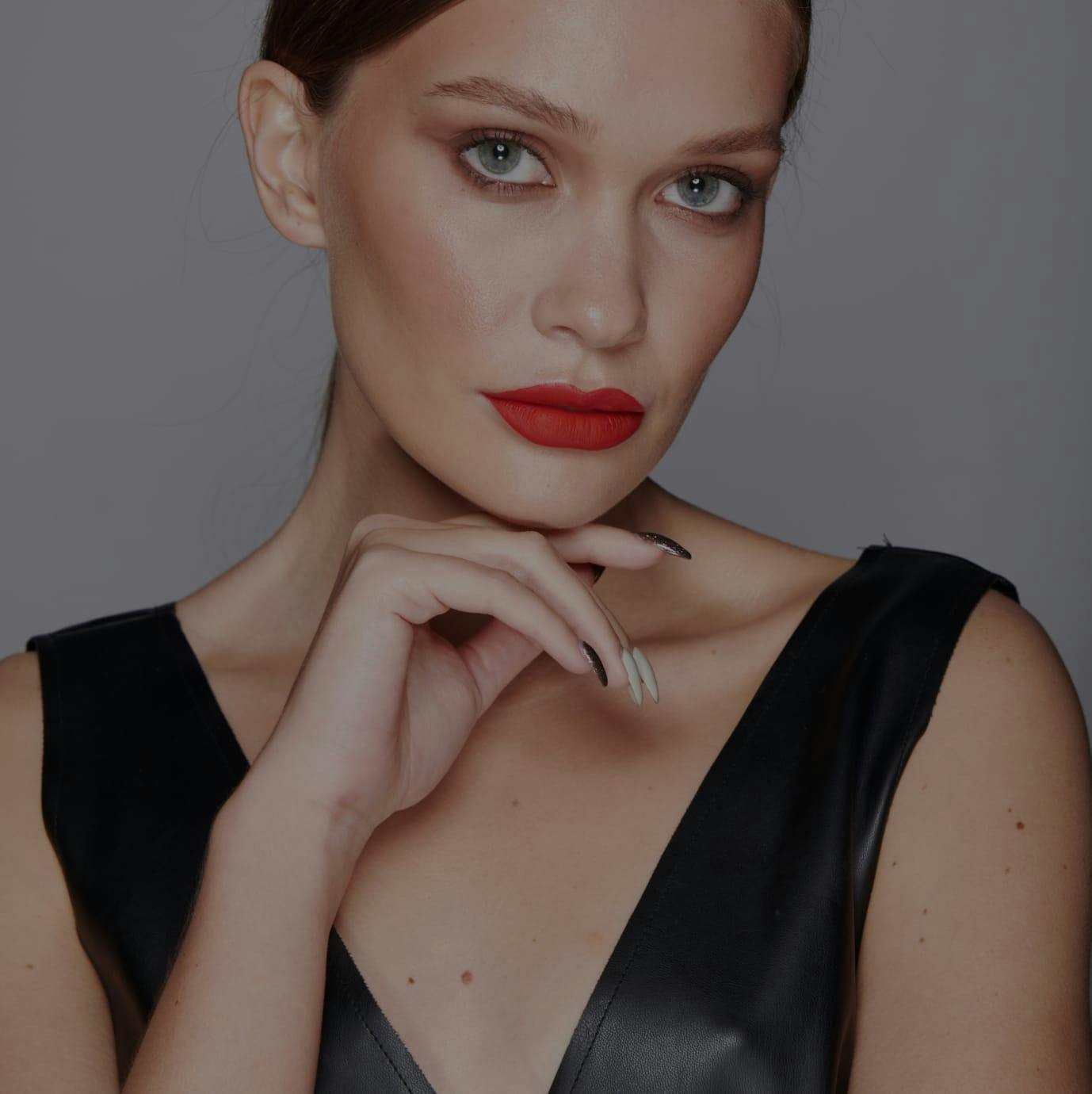 woman, not smiling, looking at camera