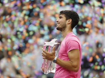 Carlos Alcaraz holds trophy after winning in 2023