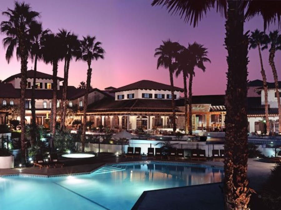 Omni Rancho Las Palmas Resort & Spa with pool at dusk