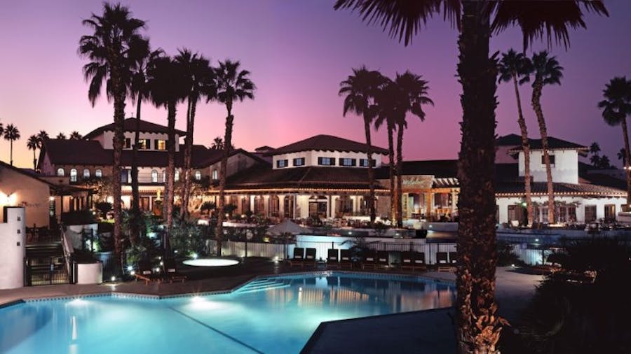 Omni Rancho Las Palmas Resort & Spa with pool at dusk