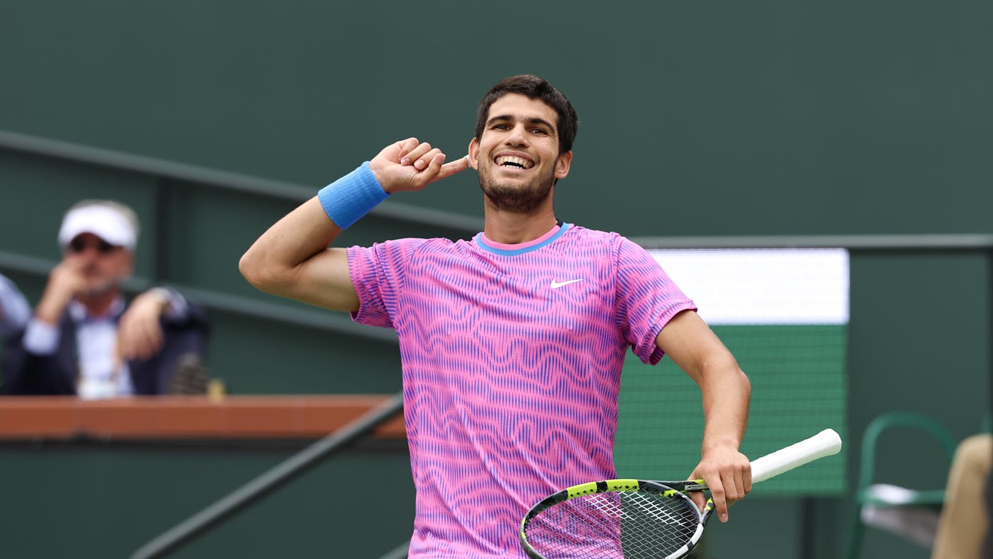Carlos Alcaraz touches his ear to encourage cheering fans during his 2024 final against Medvedev.