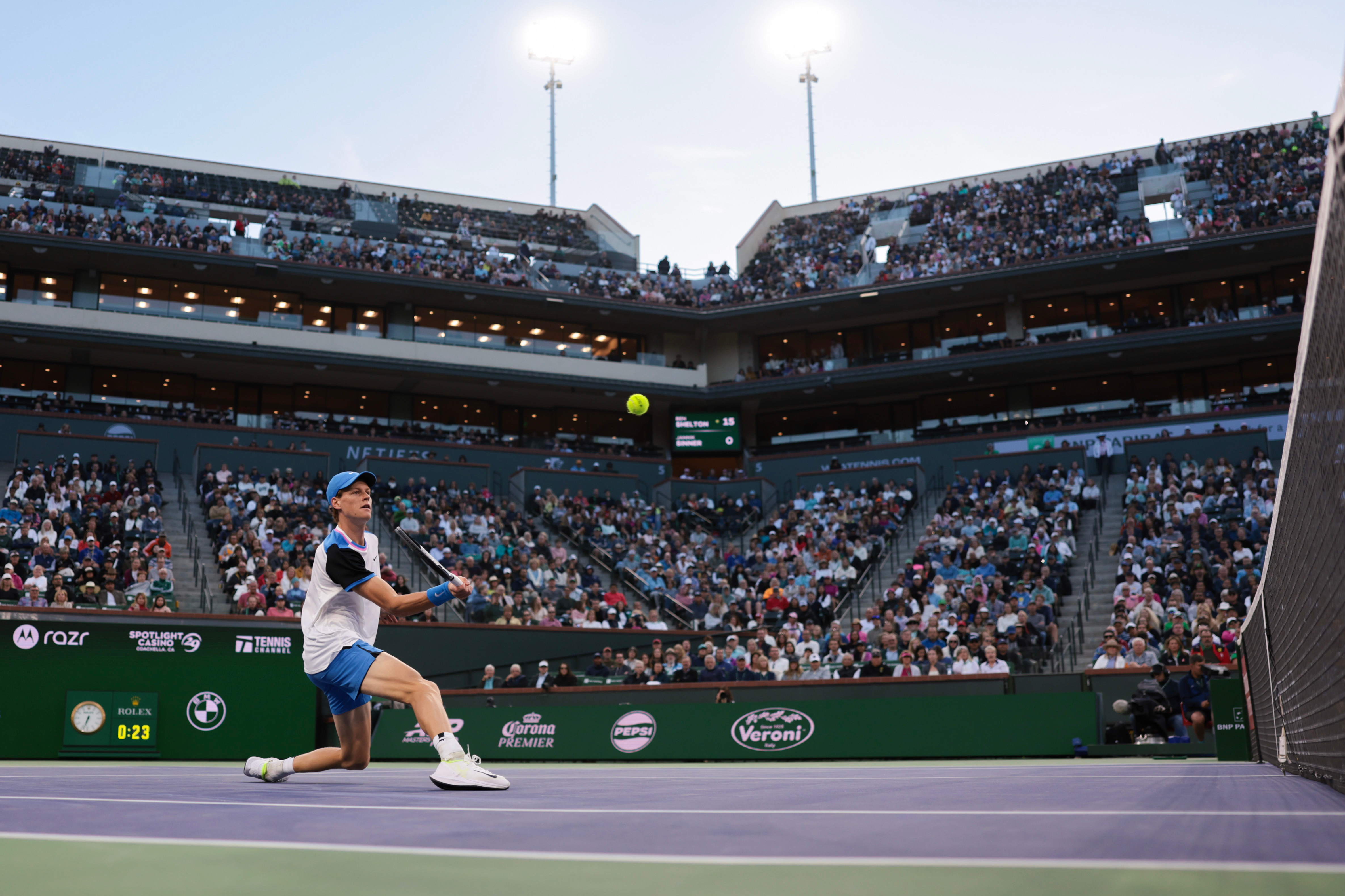 Sinner lunges to return a difficult shot.