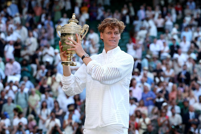 Jannik Sinner lifts the Wimbledon trophy for the second consecutive year.