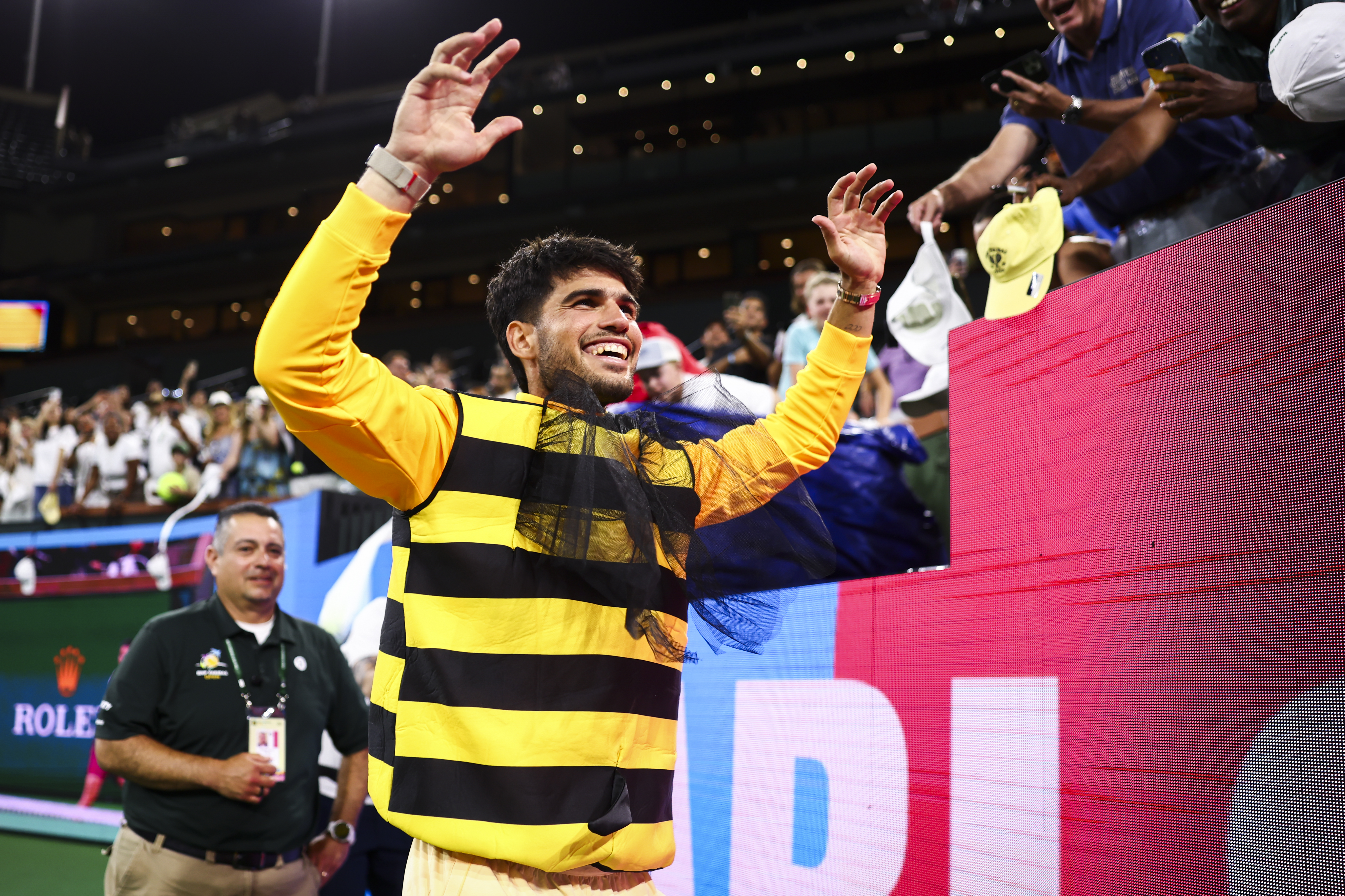 Carlos Alcaraz dons a bee suit provided by fans.