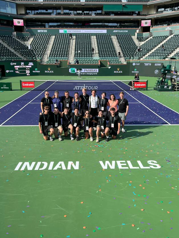 Members of the Hawk-Eye team gather inside Stadium 1 after another job well done in 2026.