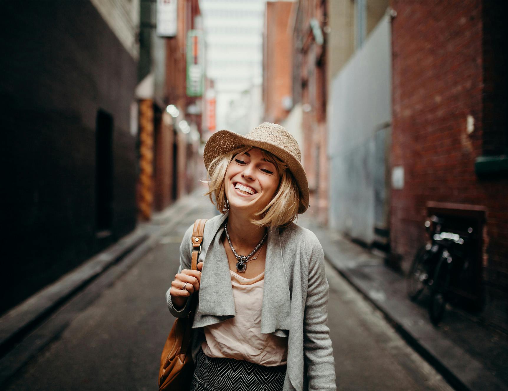 smiling on walk down city alley