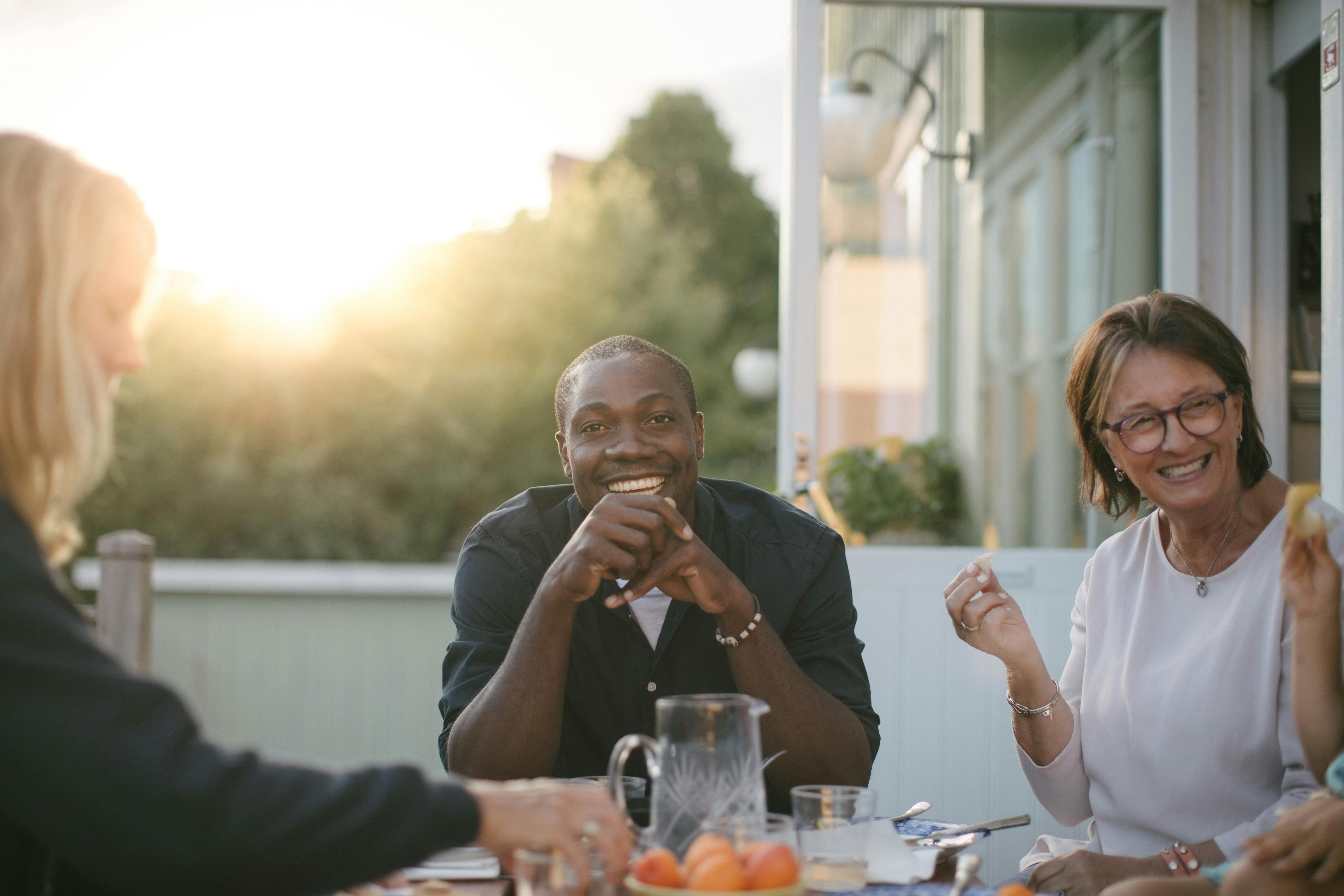 Multi-generational family having an outdoor lunch on a patio