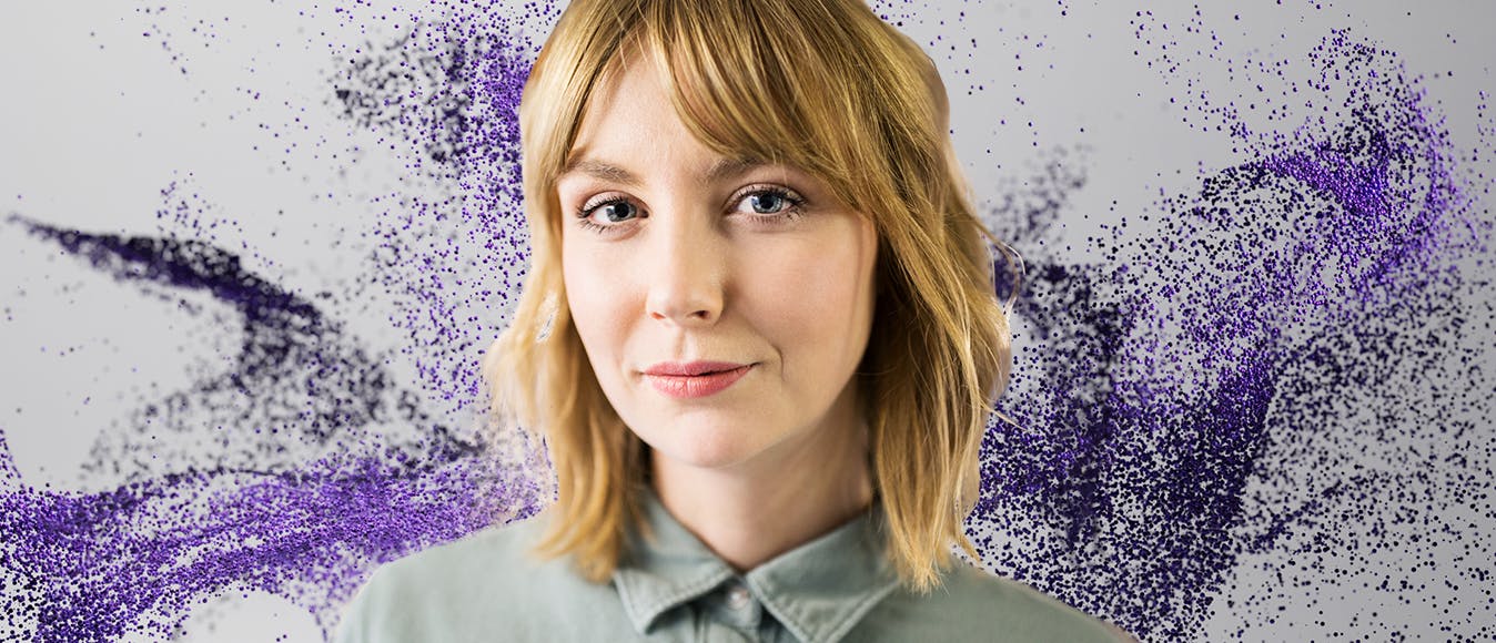 Portrait of a business woman against a purple particle background