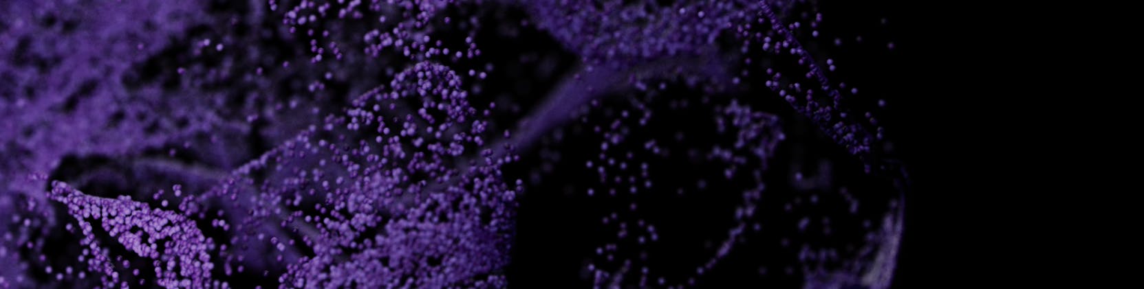 Abstract image featuring clusters of small purple particles floating against a dark background, creating a sense of motion and depth.