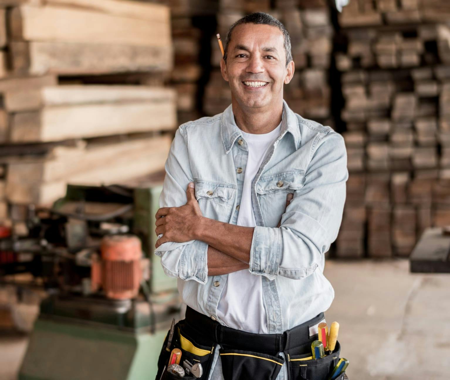 Construction worker smiling and crossing his arms