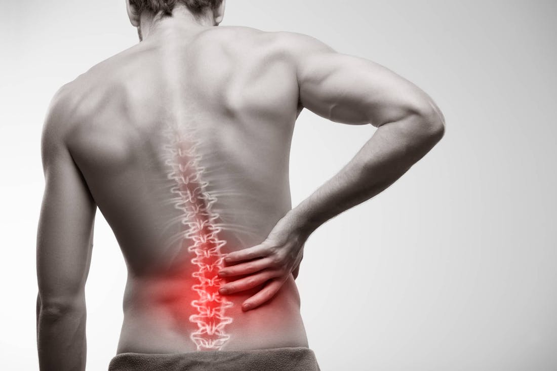 Man holding lower back in pain