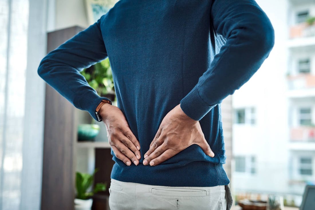 Man holding lower back in pain