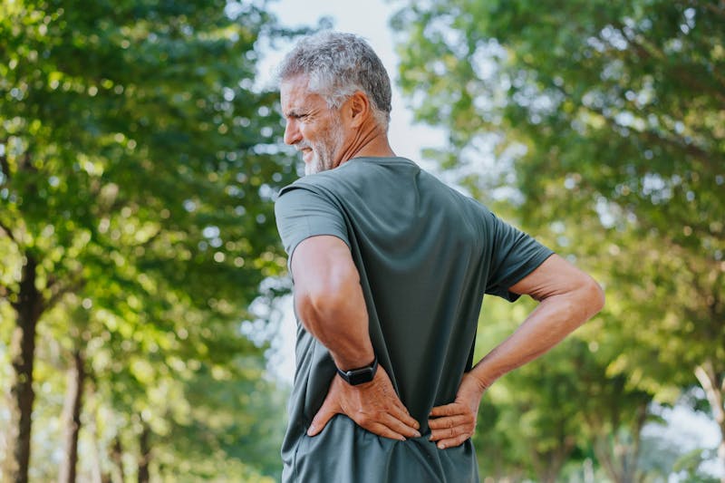 Man holding lower back in pain
