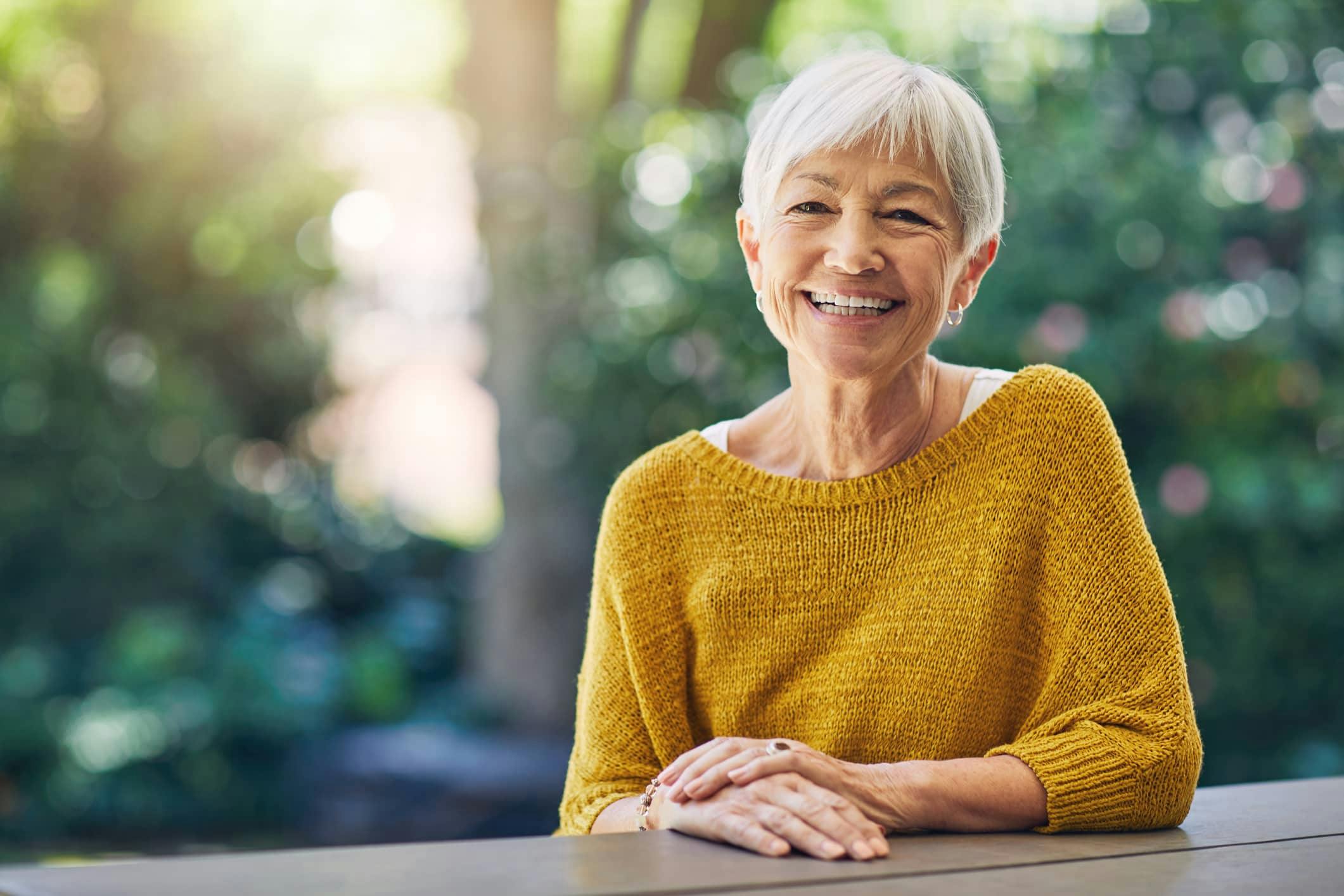 older woman smiling outside