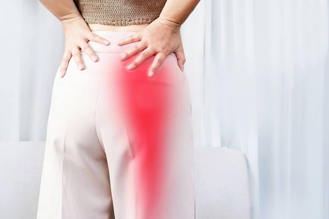 Woman holding lower back in pain