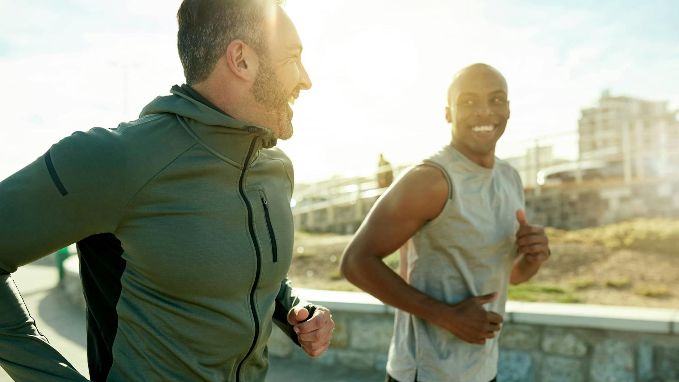 Two men jogging and smiling
