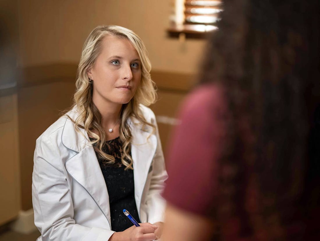Courtney Brennan listening to patient