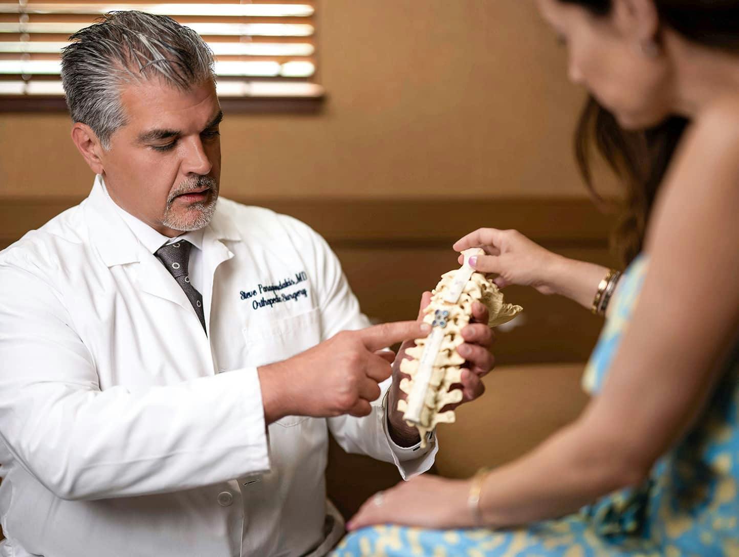 Dr. Steve Paragioudakis showing patient model of the spine
