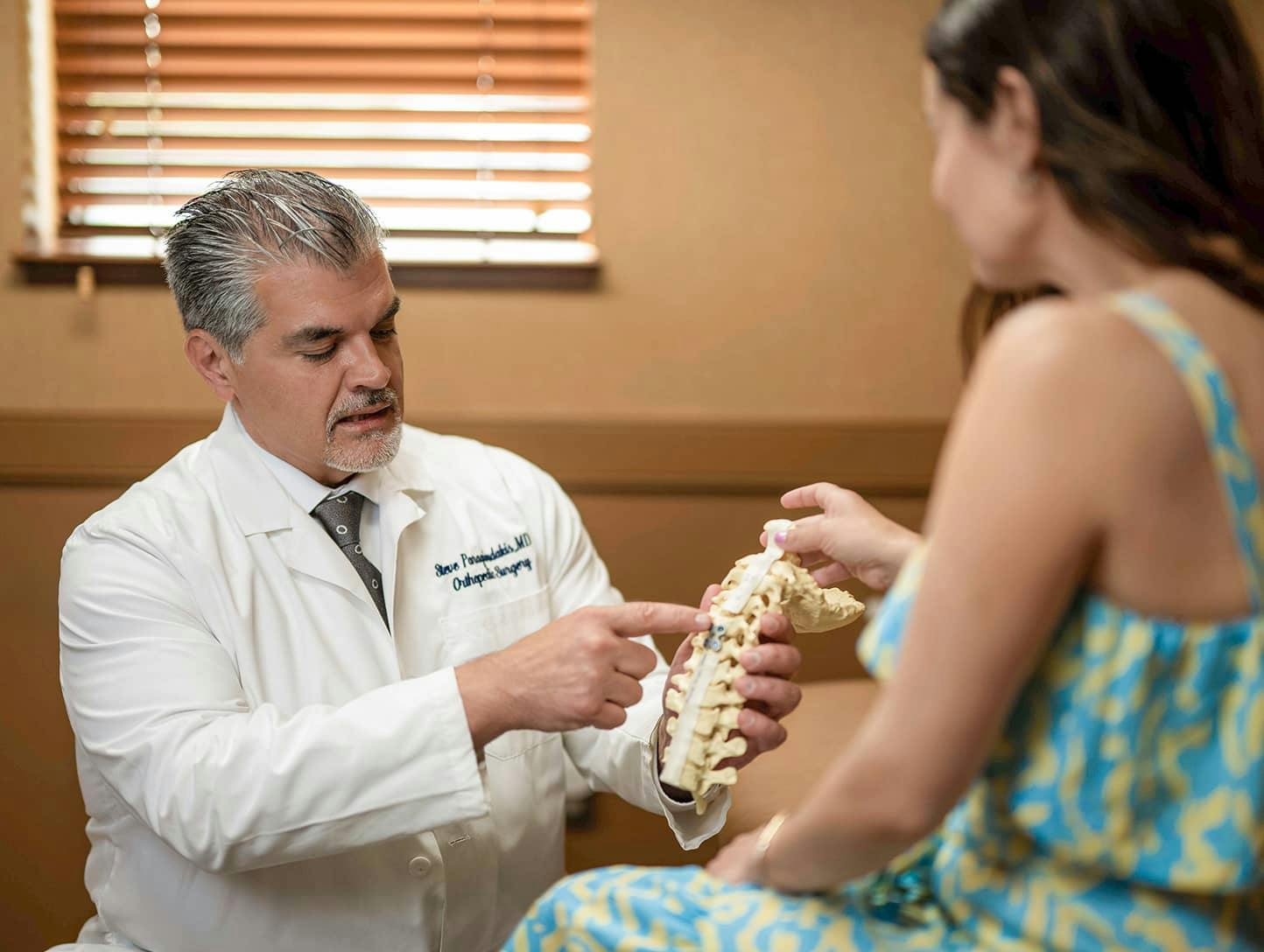 Dr. Steve Paragioudakis showing patient Spine Anatomical Model